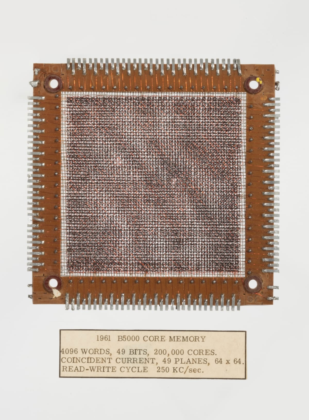 Square of woven material in frame; also contains text label underneath