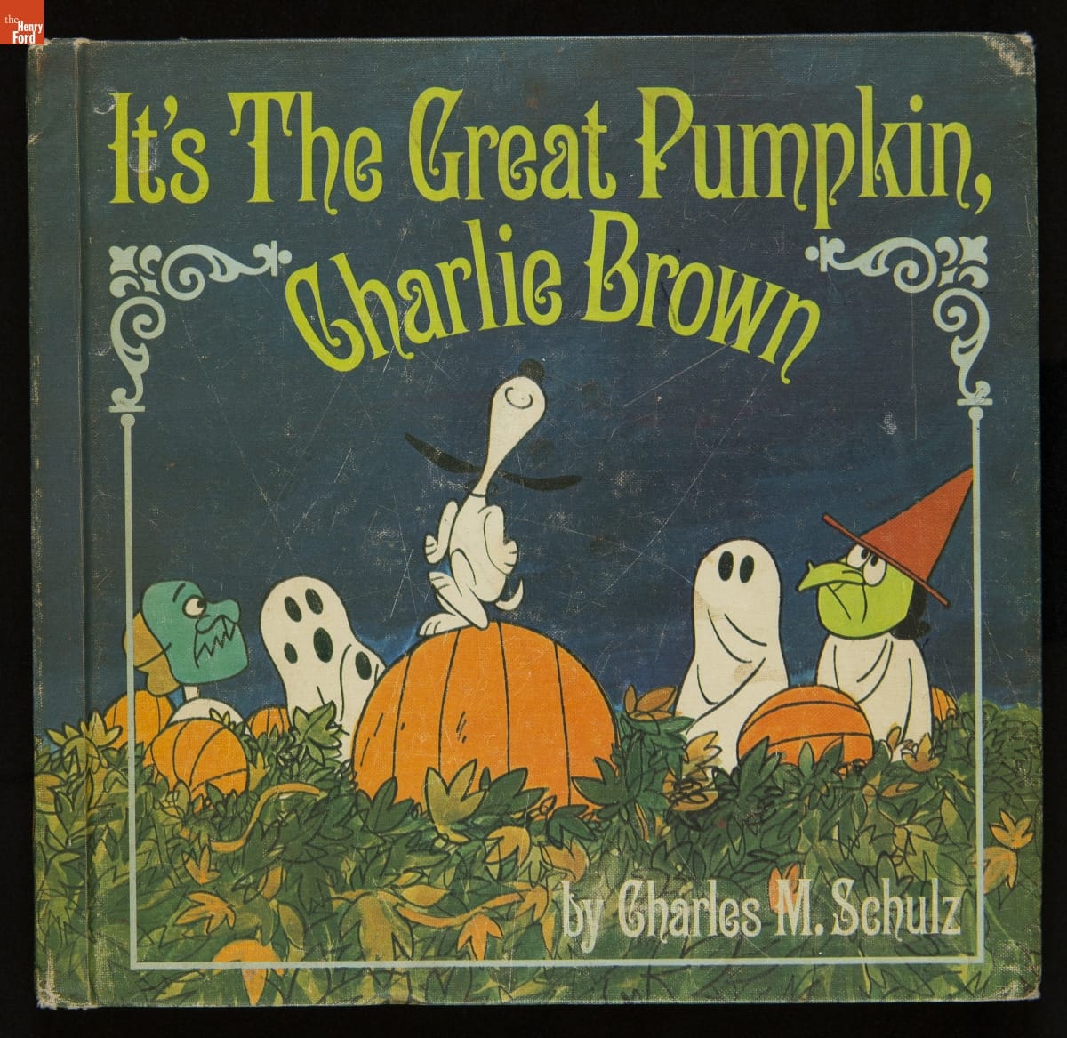 Book cover with text and image of Snoopy dancing on a pumpkin in a field with other characters in Halloween costumes nearby