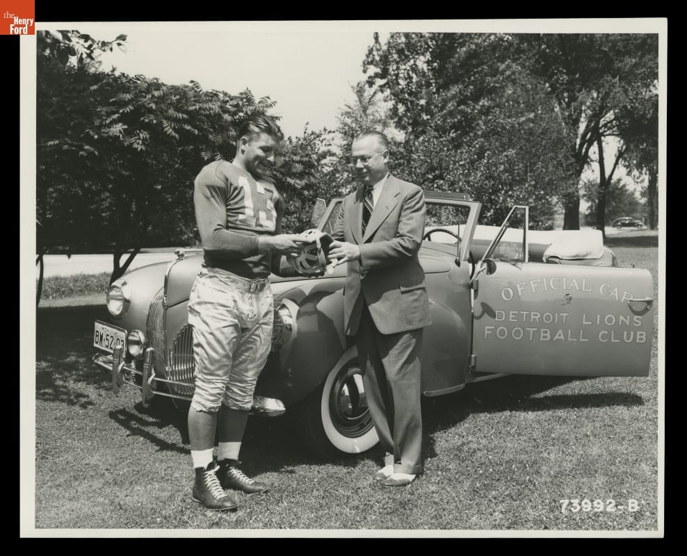 Auto Dealer Stark Hickey and Detroit Lions Player Clem Crabtree with a 1941 Lincoln Zephyr