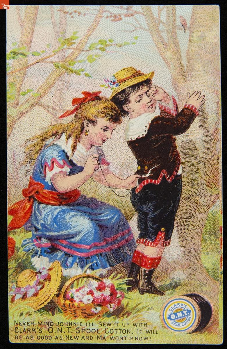 Young girl sews the back of a young boy's jacket in an area with trees; also contains text