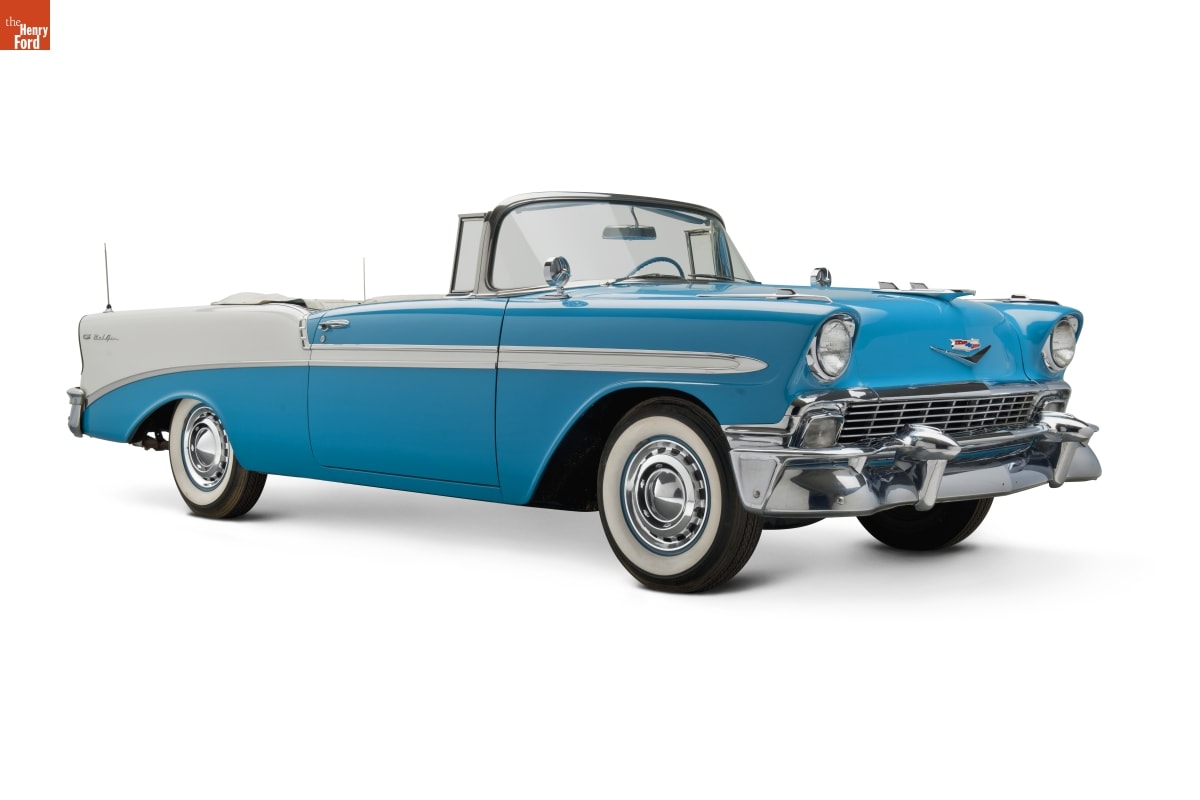 Long baby blue and white convertible car with whitewall tires