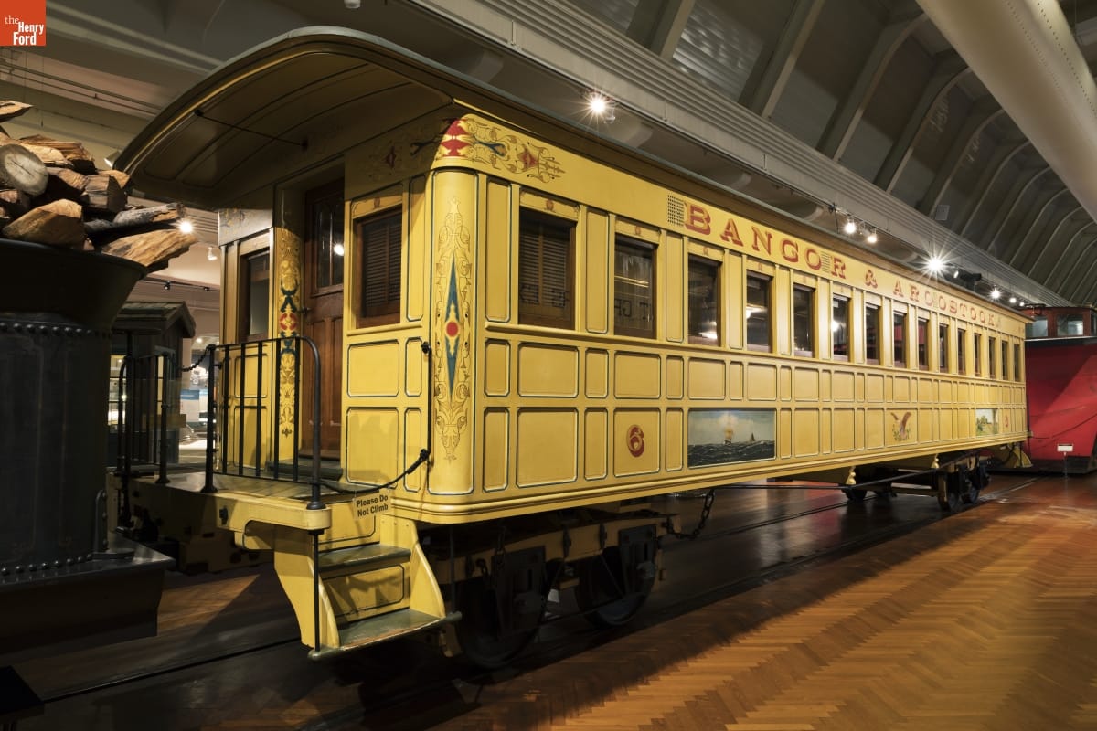 Yellow railcar with decorative elements inside large building