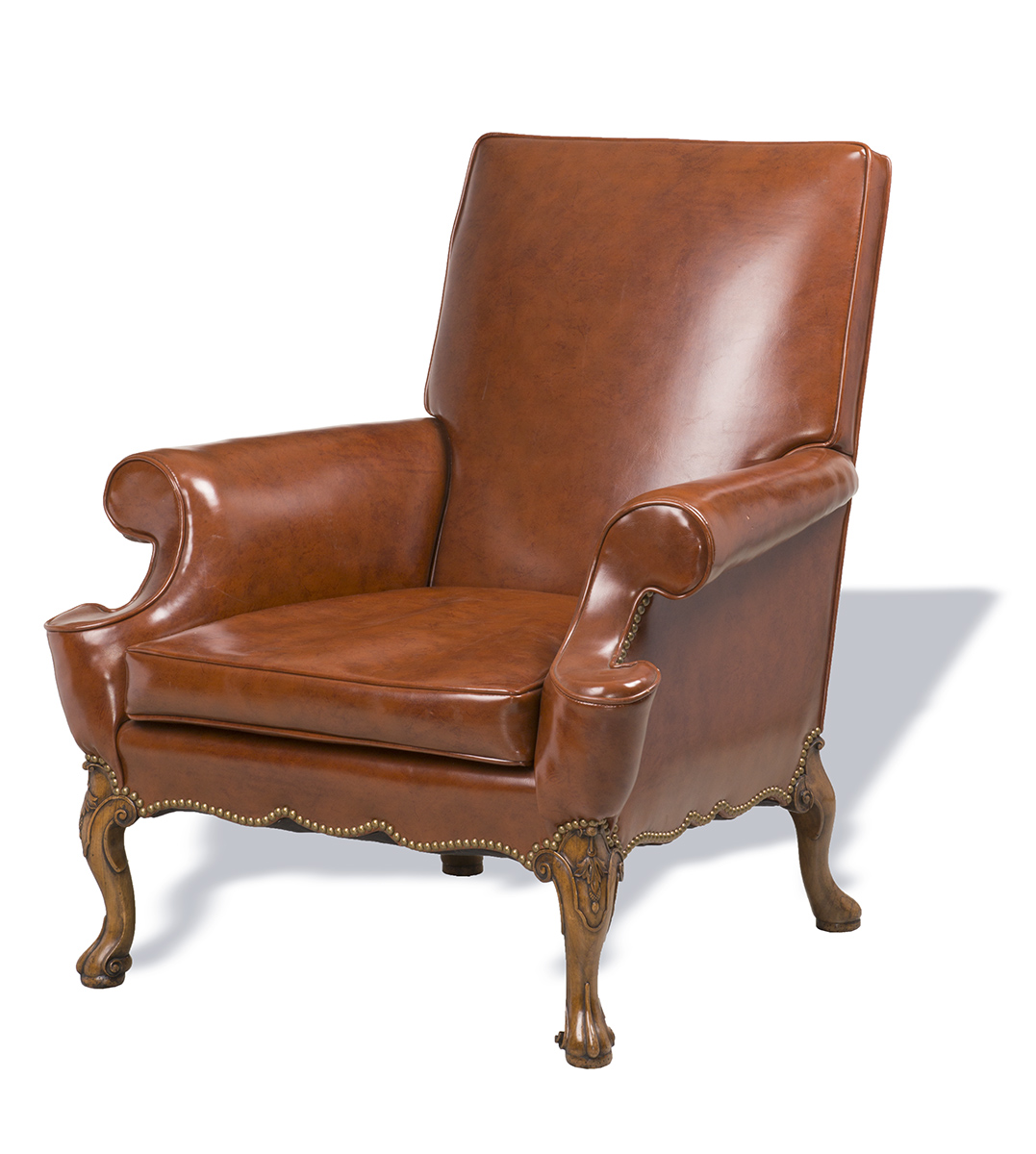 Brown leather easy chair with wooden legs