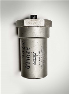 Silver cylinder with hexagonal shape on top and writing on body