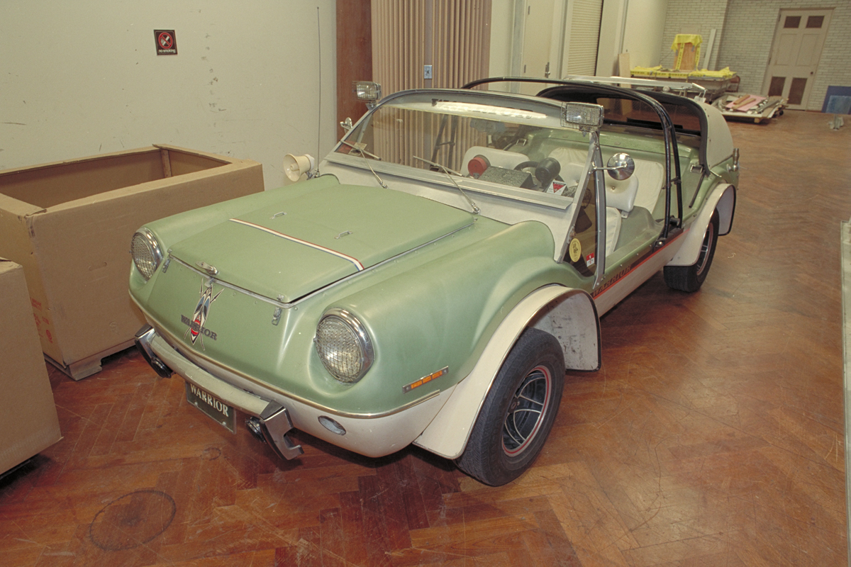 Green-and-beige doorless, open top vehicle