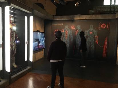 “Become Iron Man” interactive in "Marvel: Universe of Super Heroes" exhibit Person looking toward intersection of two walls with images and text