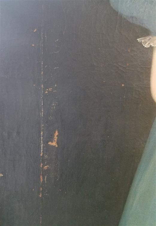 Close up of black paint showing brown chips