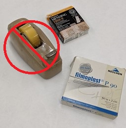 Archival document repair tape (mending tissue and Filmoplast) -- never use non-archival tape Tape dispenser with red "do not use" symbol over it, plus two boxes