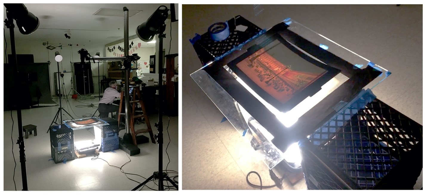 Photographer Rudy Ruzicska taking the perfect image of a megalethoscope slide.. lights on tripods pointing at glass plate stretched across milk crates; man kneeling nearby