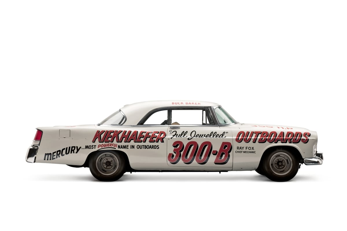 Side view of white car with red and black text on the side