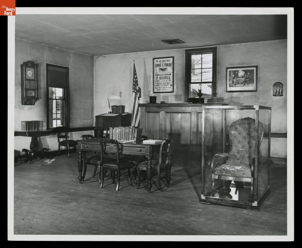 Logan County Courthouse in April 1954, Showing the Abraham Lincoln Chair Then on Exhibit in Greenfield Village Interior of room containing upholstered rocking chair in case, along with other furniture