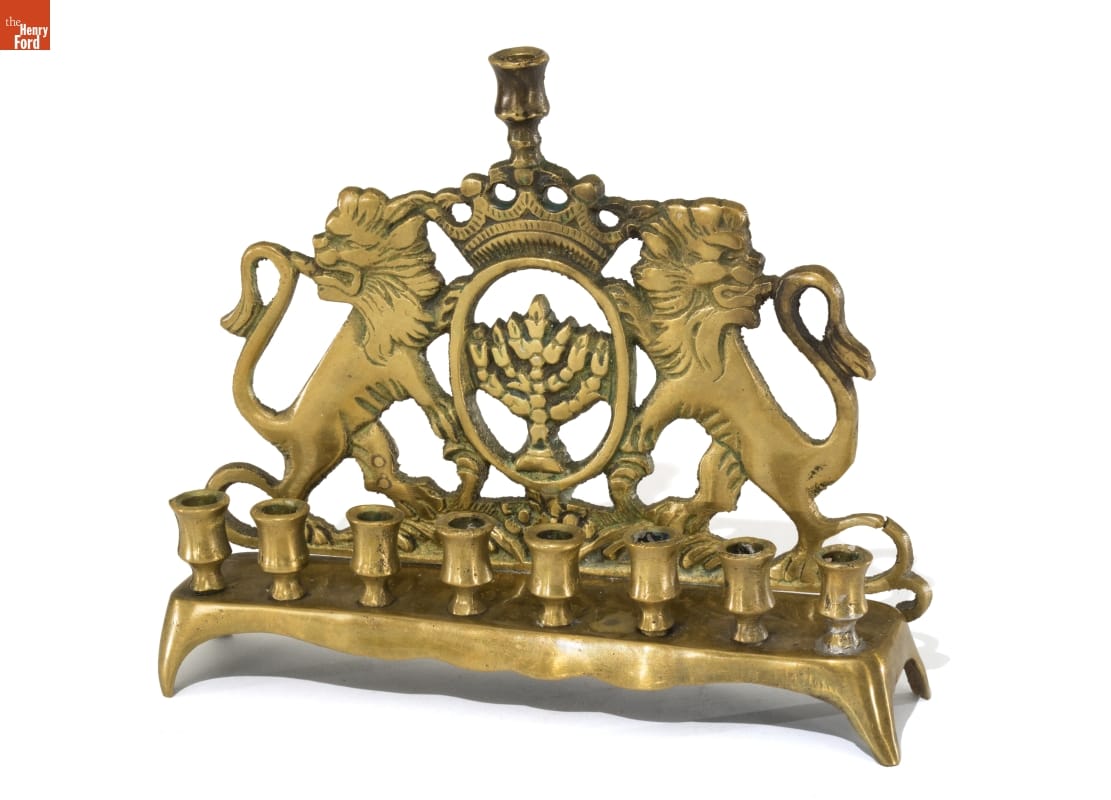Hanukkah Lamp, 1900-1920 Brass candlestand with 9 spots for candles and backing with lions and a crown