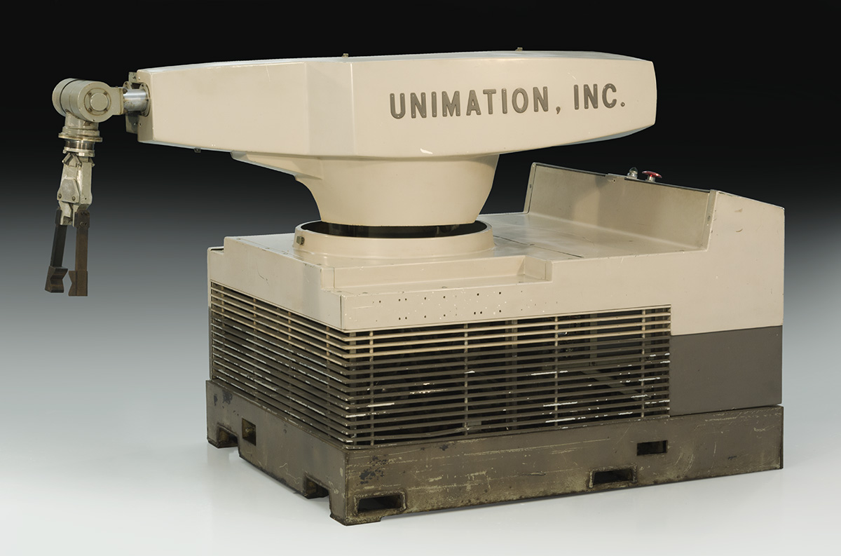 Large, squat beige robot with a swing arm and text "UNIMATION, INC." on side