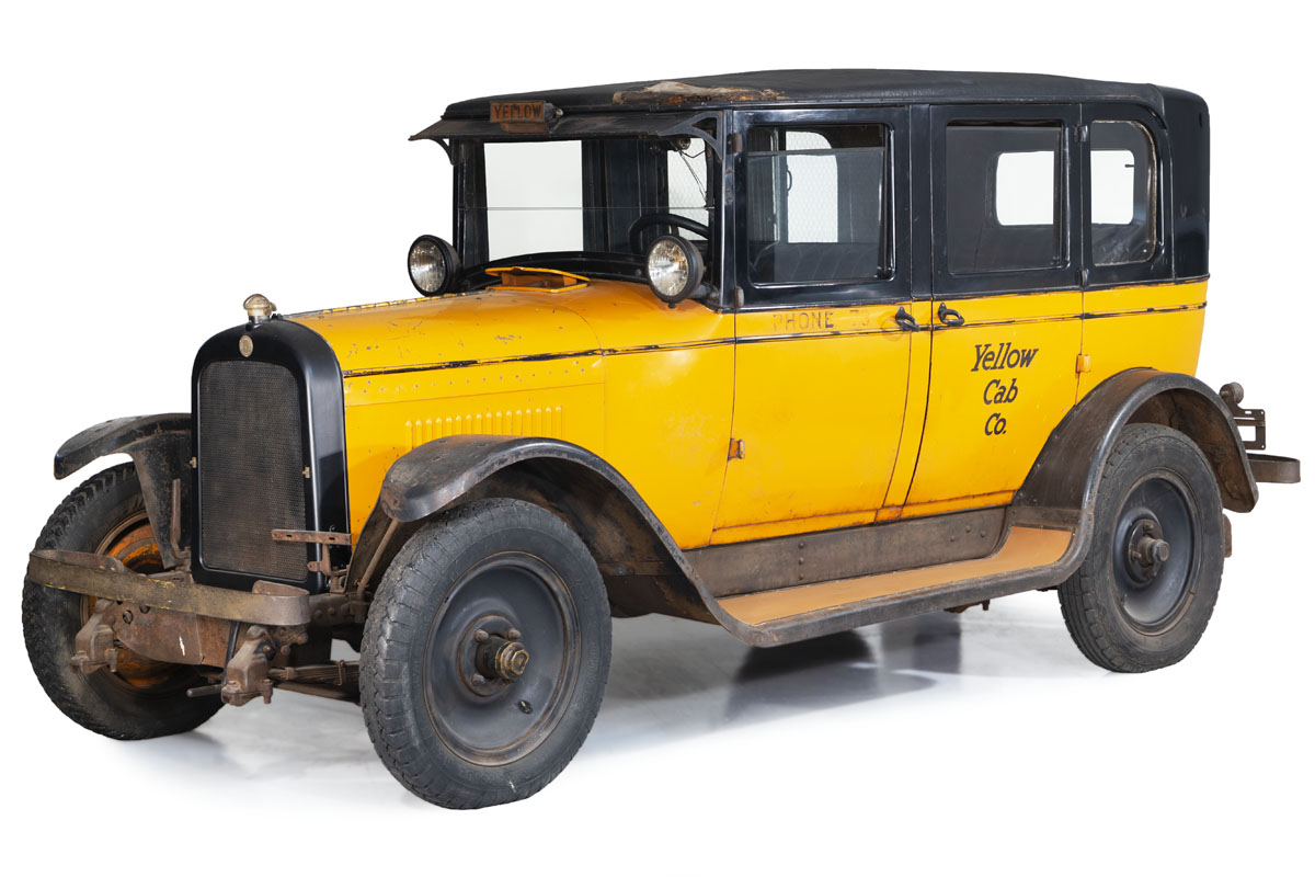 Yellow and black car with text "Yellow Cab Co." on side