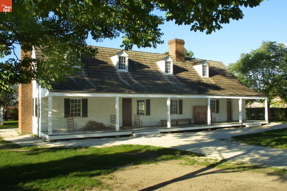 Long white house with sloped roof and open porch