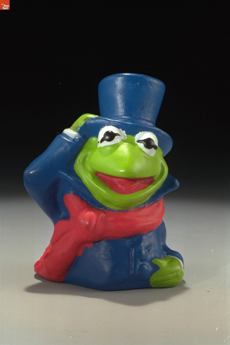 Frog wearing blue top hat and jacket and red scarf