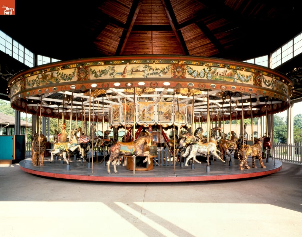 Carousel containing a variety of animals in dome-ceilinged building