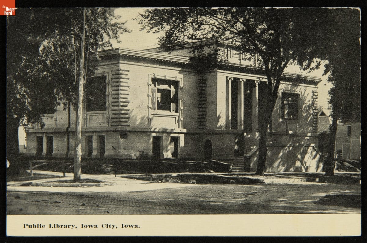 Postcard photo of the front street view of a public library in Iowa City, Iowa in 1904