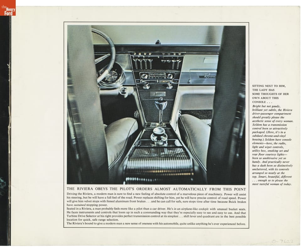 Partial view of car console and front seats taken from backseat