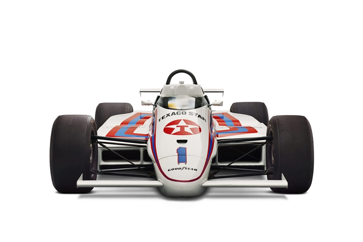 1984 March 84C-Cosworth Race Car Head-on view of a low white race car with wide wheels