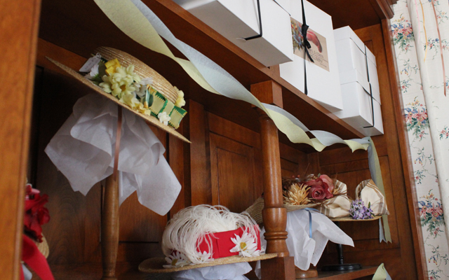Wall display of hats for sale at Cohen Millinery